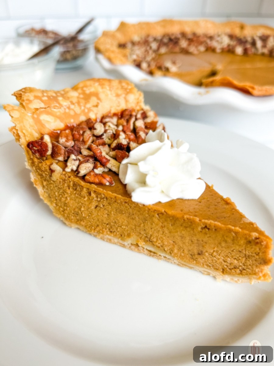 Velvety Pumpkin Custard Pie 9 Slice of pumpkin pie on a plate.