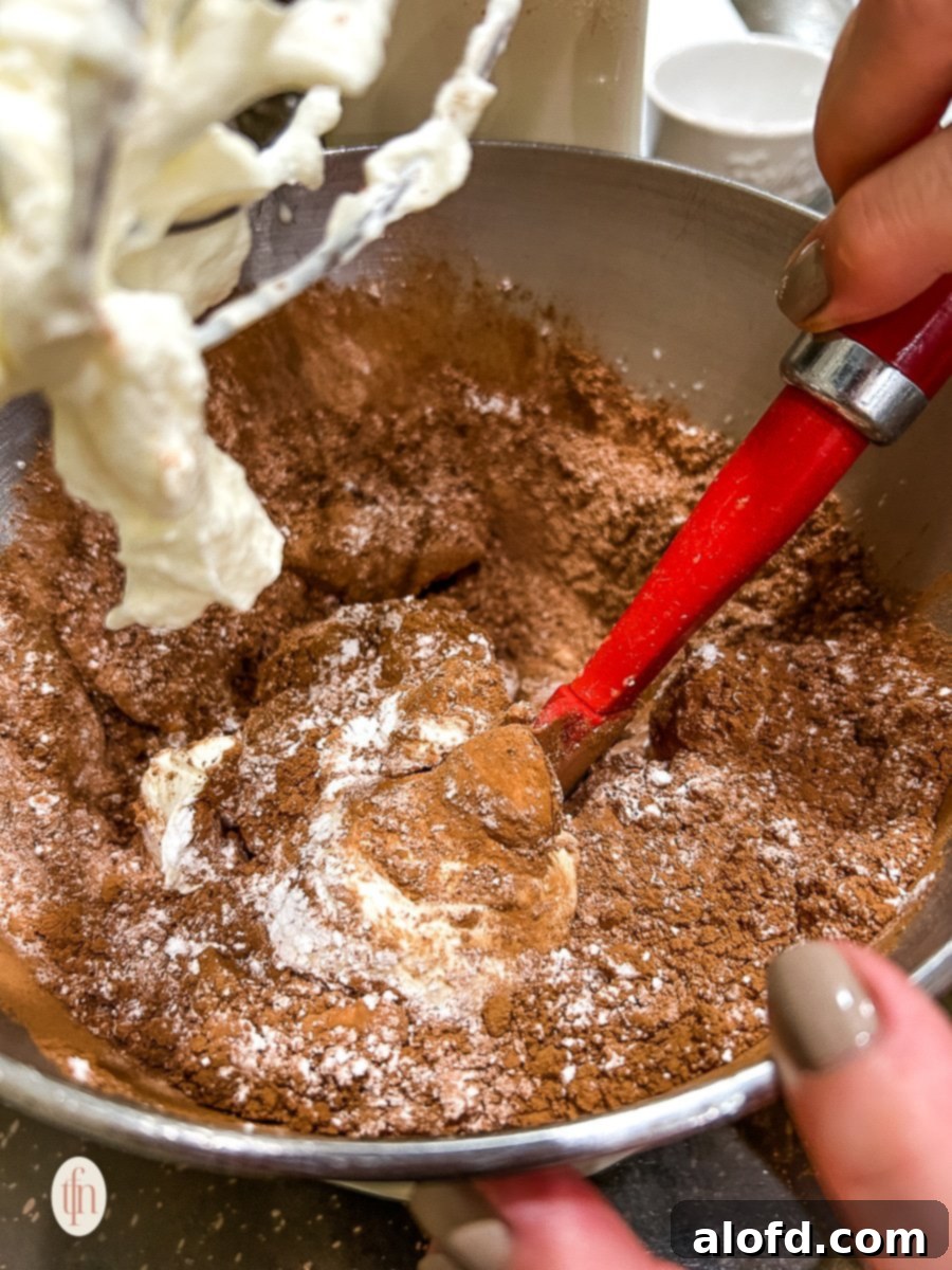 Simple Decadent Chocolate Mousse 8 Stirring chocolate and cream in a metal bowl.
