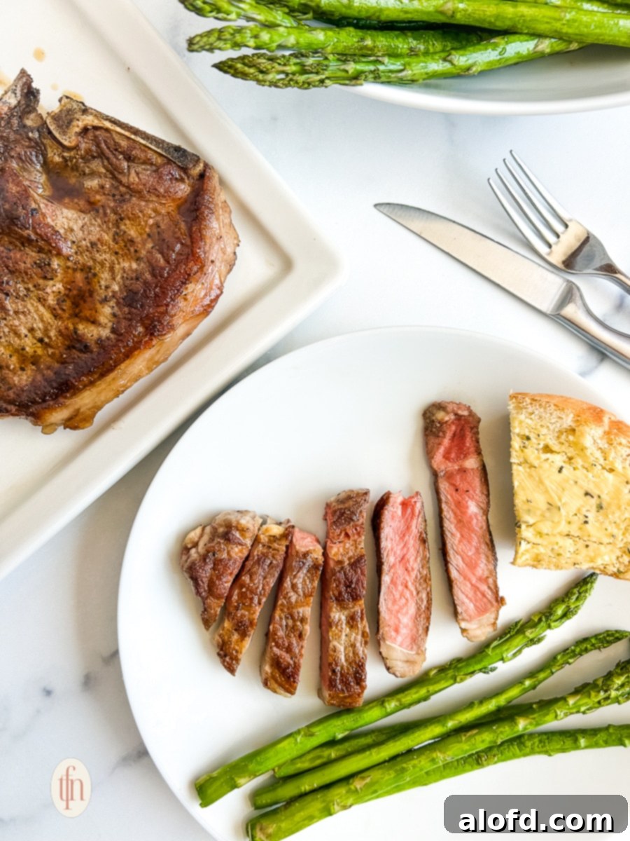 Beautifully plated and sliced shell steak with vibrant green asparagus, garnished and ready for a gourmet meal.