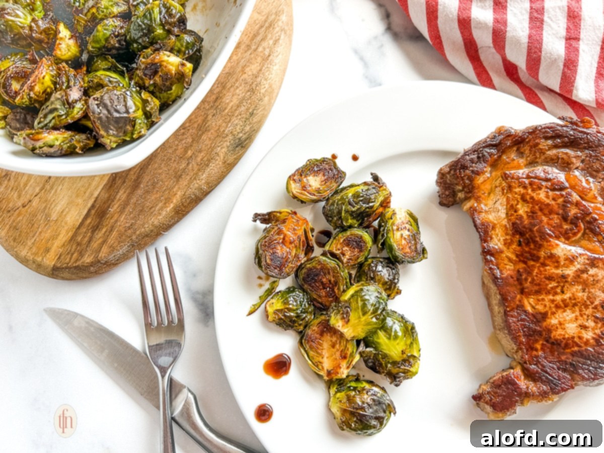 Horizontal image of maple brussel sprouts on a white plate, showcasing the dish from a wider perspective. 