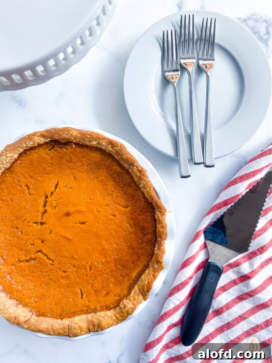 Thanksgiving side dish on table next to utensils.