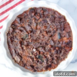 Chocolate sourdough bread pudding in a white pie dish.