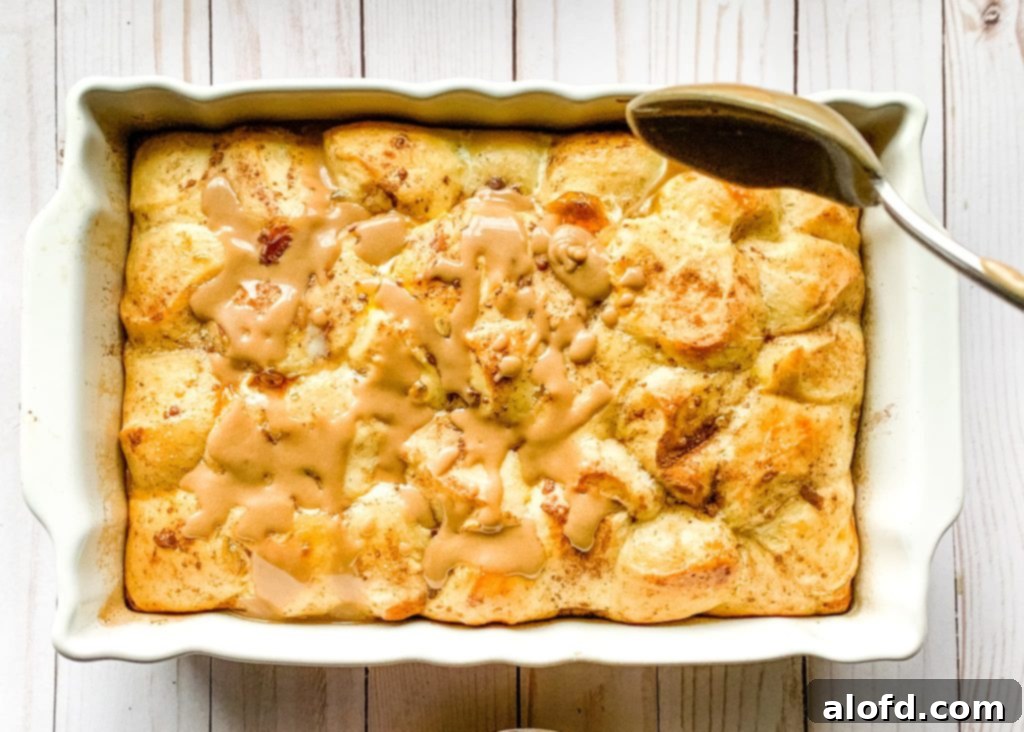 Effortless Overnight French Toast Bake 9 A freshly baked French Toast Casserole with frozen ready dough, glistening with a sweet, creamy icing glaze and dusted with powdered sugar, ready to be enjoyed.