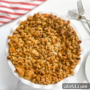 Golden Carrot Bake 10 Sweet Carrot Casserole topped with golden oats and nuts, served in a square dish.