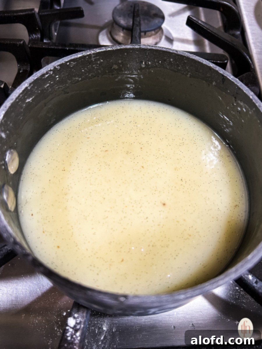 Velvety Vanilla Sauce for Bread Pudding 8 Pot of vanilla sauce on the stove.