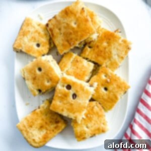 Effortless Sheet Pan Pancakes from Mix 11 A platter of beautifully baked sheet pan pancakes, cut into squares and stacked, perfect for an easy Christmas morning breakfast.