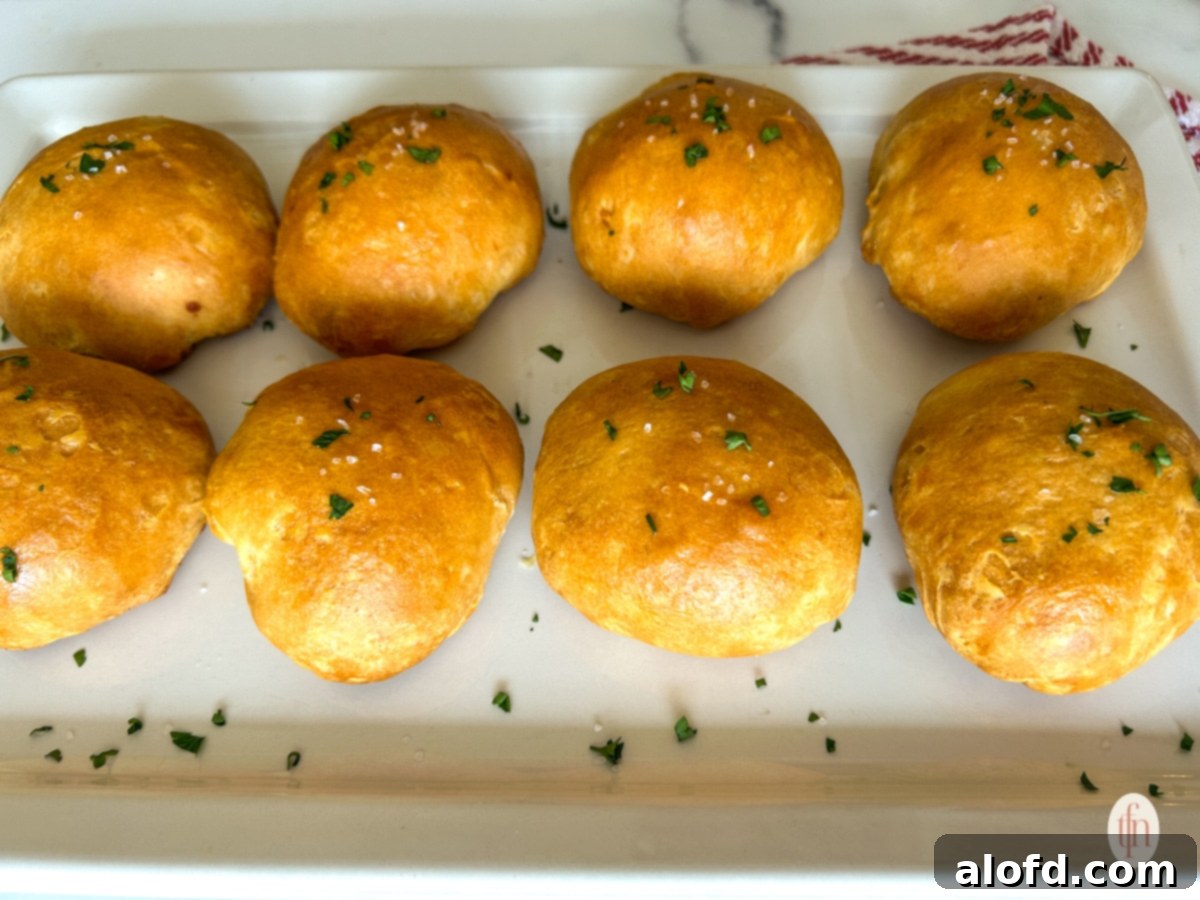 Fiery Buffalo Chicken Poppers 12 A plate brimming with golden-brown buffalo chicken bombs, garnished with fresh green parsley, ready to be served as an irresistible appetizer.