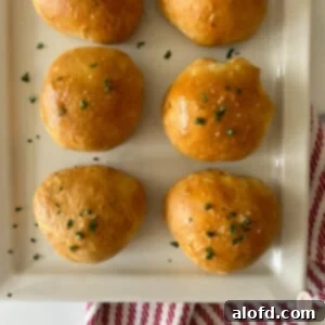 Fiery Buffalo Chicken Poppers 13 A plate of buffalo chicken balls topped with parsley, showcasing their golden crust and enticing appeal.