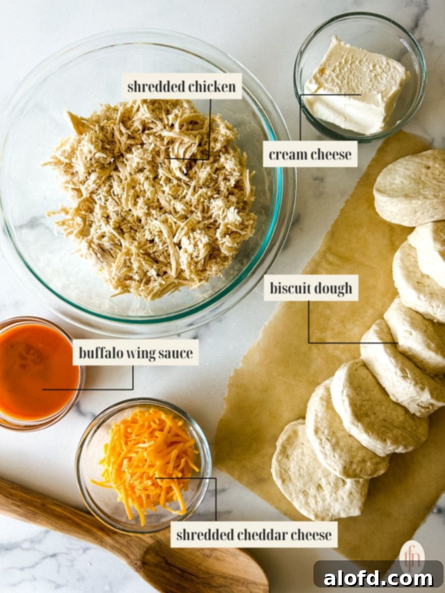 Fiery Buffalo Chicken Poppers 4 Labeled ingredient image featuring shredded chicken, cream cheese, buffalo sauce, and cheddar cheese, alongside biscuit dough for the buffalo chicken biscuit bomb recipe.