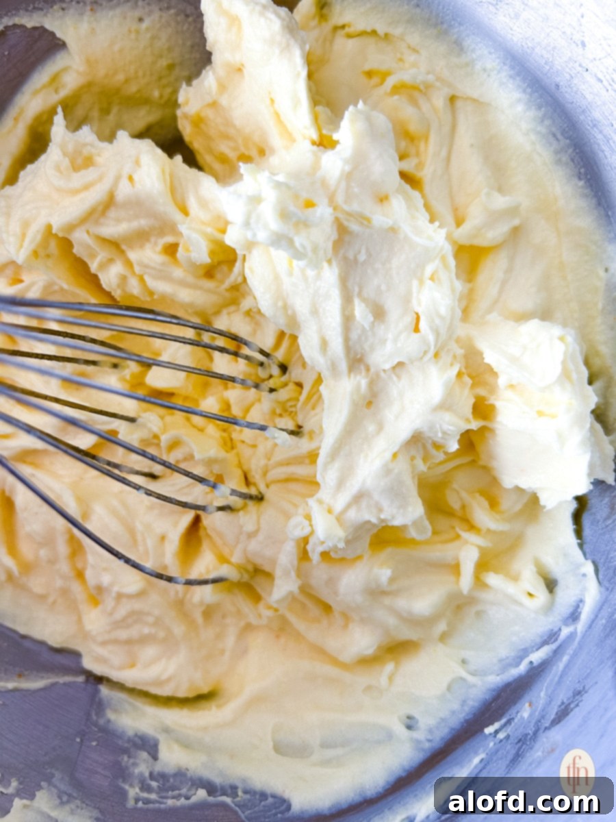 Velvety Vanilla Cloud 5 Whisking ingredients together in a bowl.