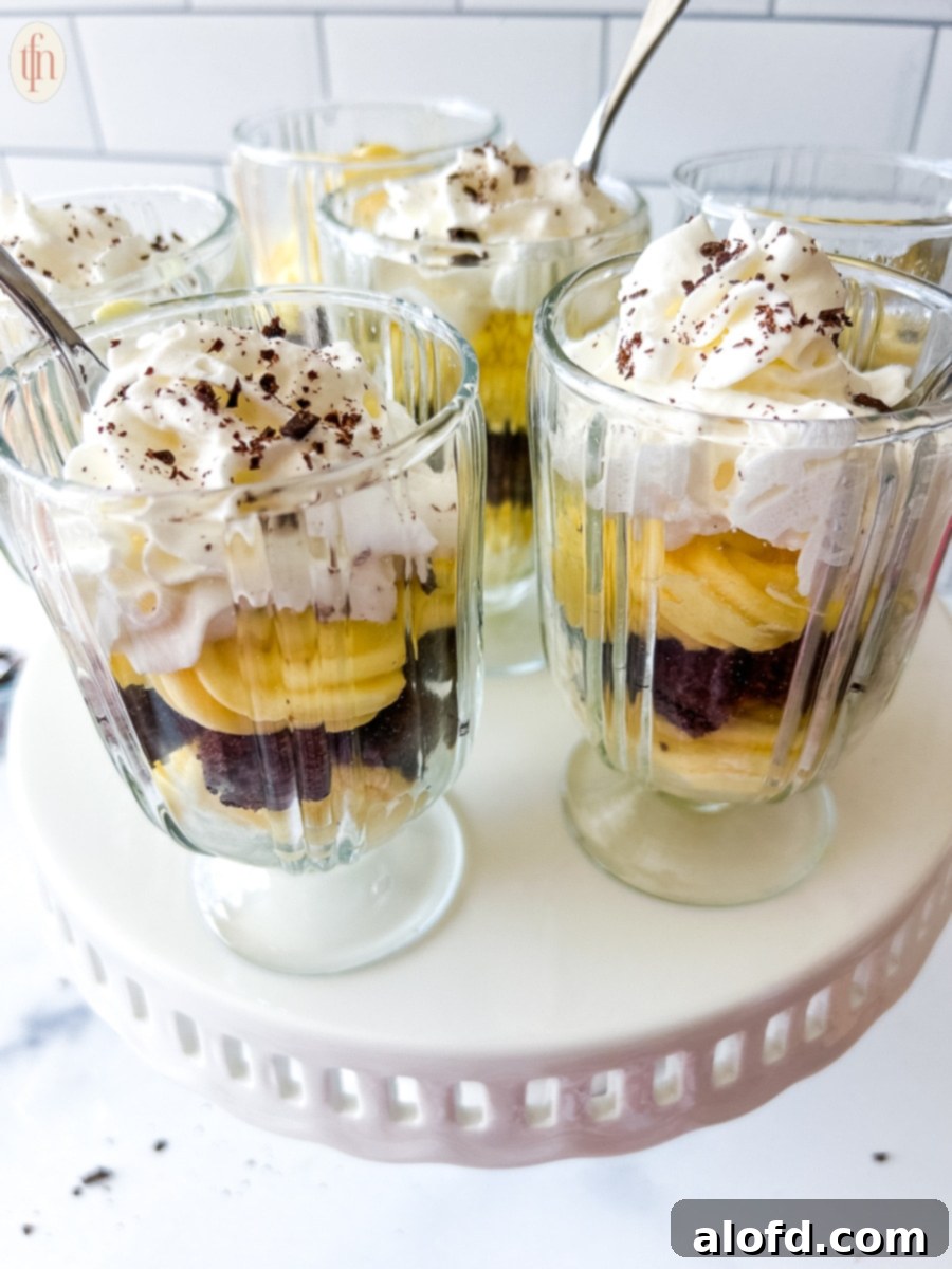 Velvety Vanilla Cloud 9 Three glasses of parfait with spoons sticking out of the tops.