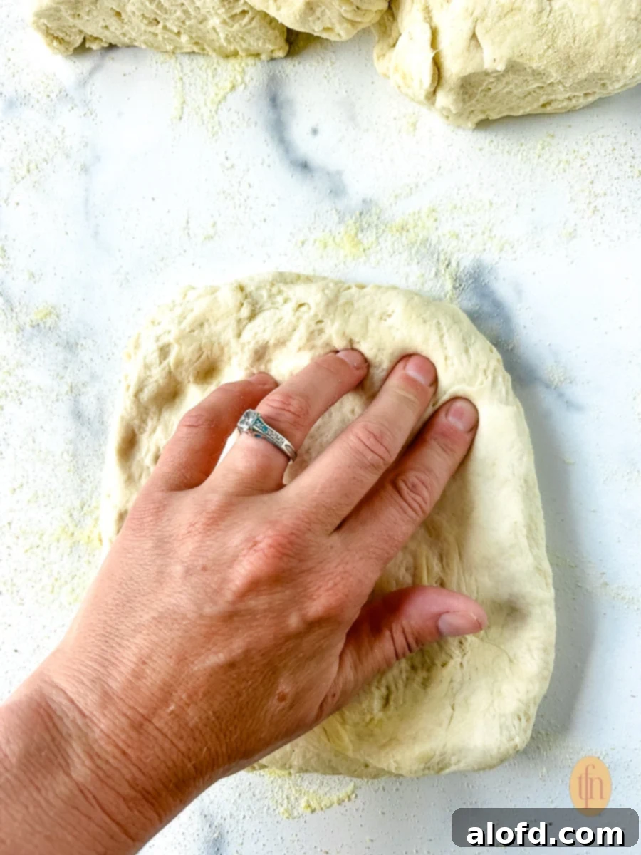 Woman pushing her fingertips into an unbaked crust.