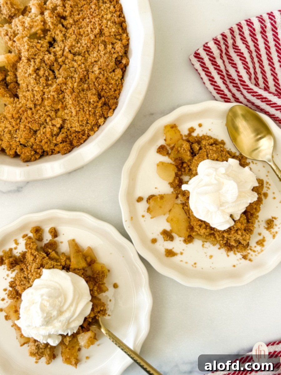 Two plates of pear crumble on a white background.