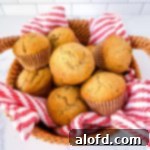 Sourdough Discard Demystified 16 Sourdough banana muffins in a wicker basket with a striped tea towel.