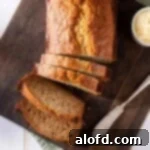 Sourdough Discard Demystified 19 a loaf of sliced banana bread on a wooden cutting board.