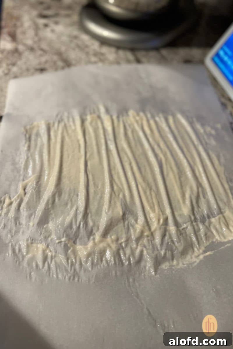 Sourdough Discard Demystified 9 Sourdough starter spread on a parchment paper.