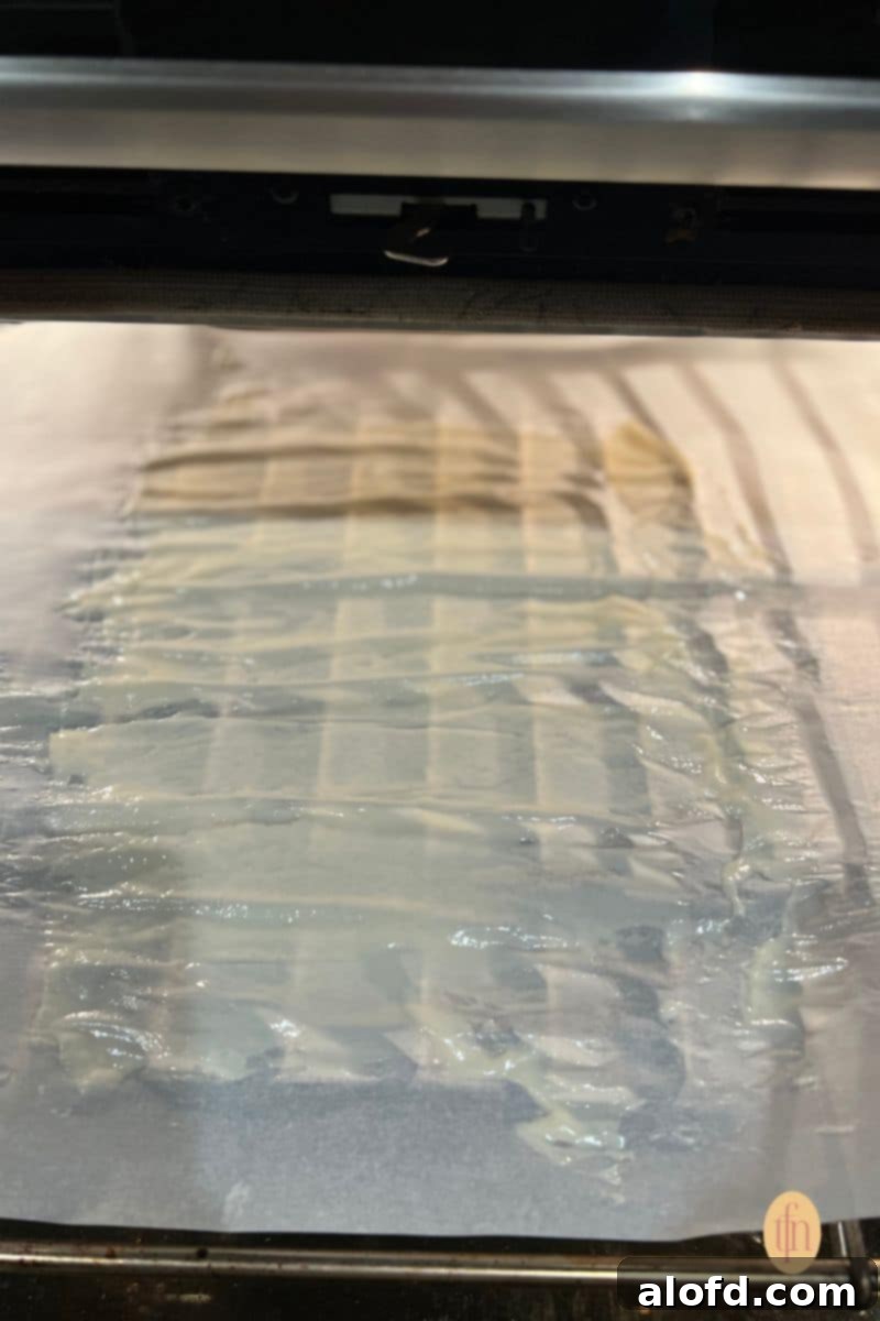 Sourdough Discard Demystified 10 Sourdough starter spread on a parchment paper.