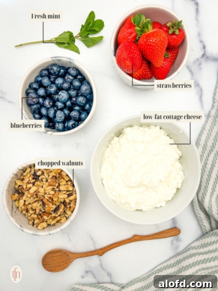 Nourishing Cottage Cheese Creation 5 Labeled ingredient image for fruit bowl recipe, showing cottage cheese, strawberries, blueberries, walnuts, honey, and mint.