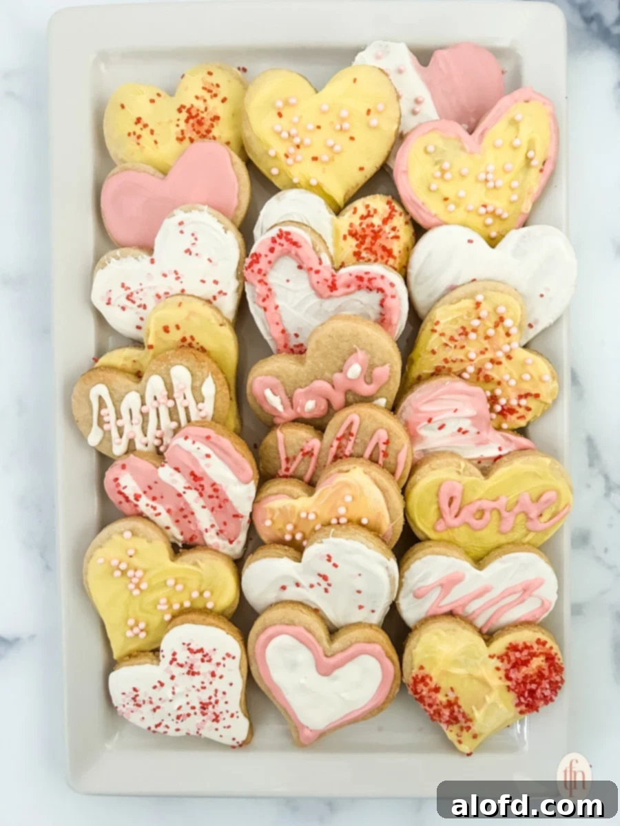 Sweetheart Delights 2 Heart sugar cookies arranged beautifully on a white plate, perfect for sharing.