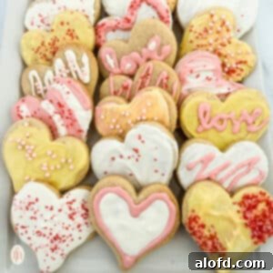 Sweetheart Delights 12 Heart sugar cookies on a white plate, beautifully decorated.