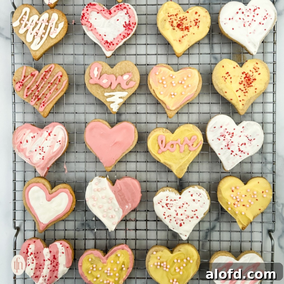 Sweetheart Delights 10 Heart sugar cookies cooling on a wire rack, freshly baked and ready for decoration.