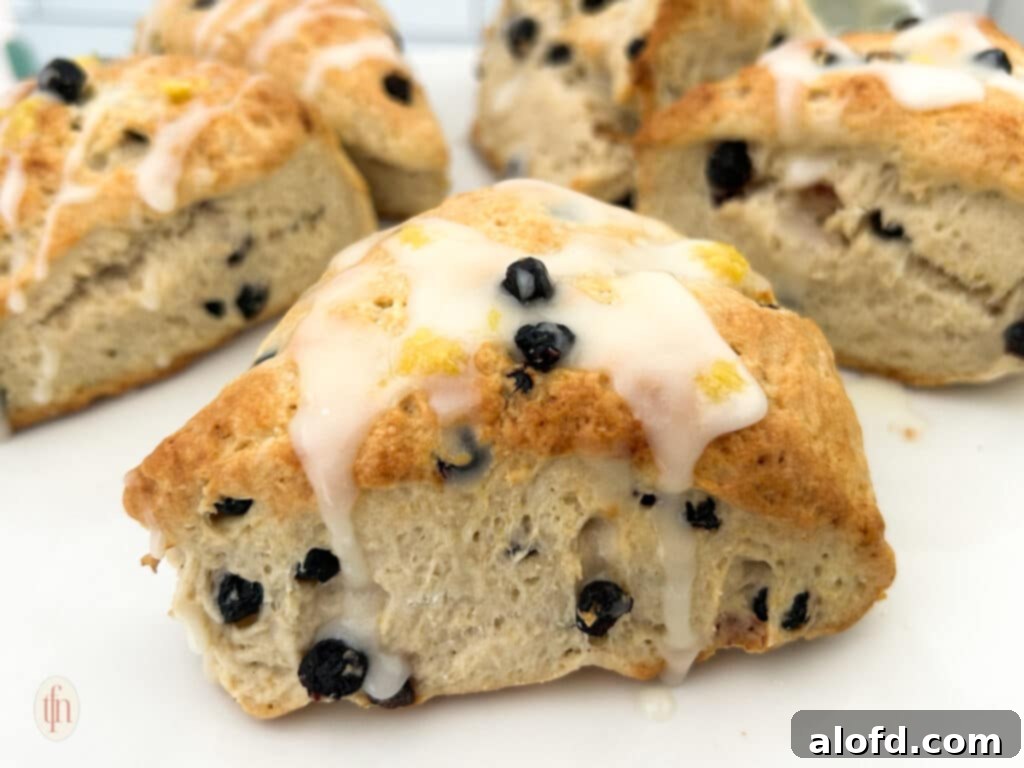 Artisan Sourdough Blueberry Scones 10 A large platter of blueberry sourdough scones, some with icing, ready for serving.