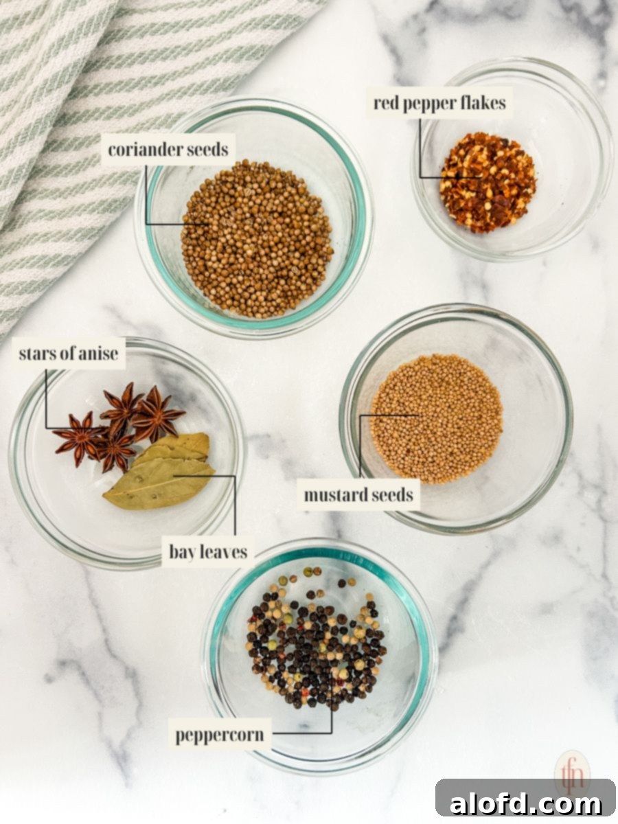 Signature Corned Beef Spice Blend 4 A selection of whole spices for homemade corned beef seasoning, neatly arranged and labeled, including coriander seeds, mustard seeds, peppercorns, star anise, bay leaves, and red pepper flakes.