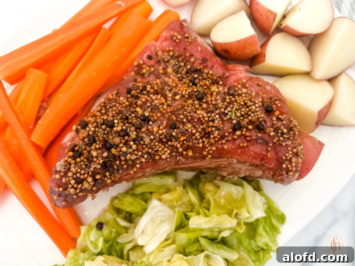 Slow-Braised Dutch Oven Corned Beef 10 Dutch oven corned beef with seasoning on top and vegetables on the side.