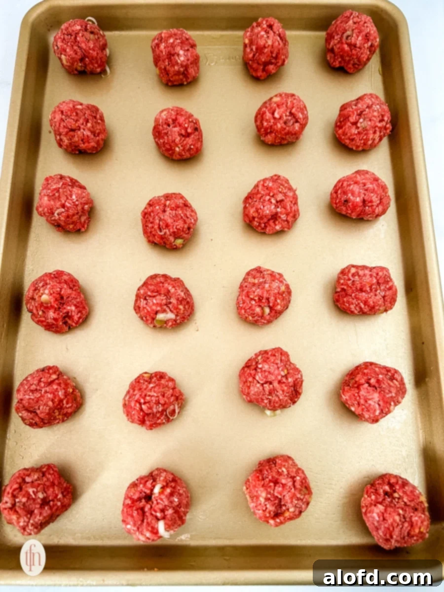 Dynamite Meatballs 7 Uncooked firecracker meatballs on a baking sheet.