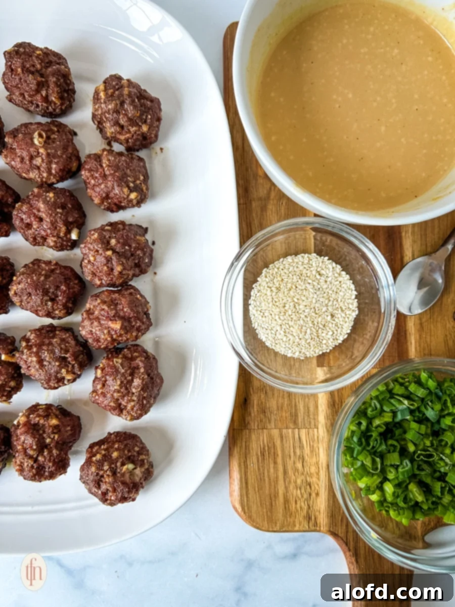 Dynamite Meatballs 8 Cooked meatballs with prepared sauce and garnish.