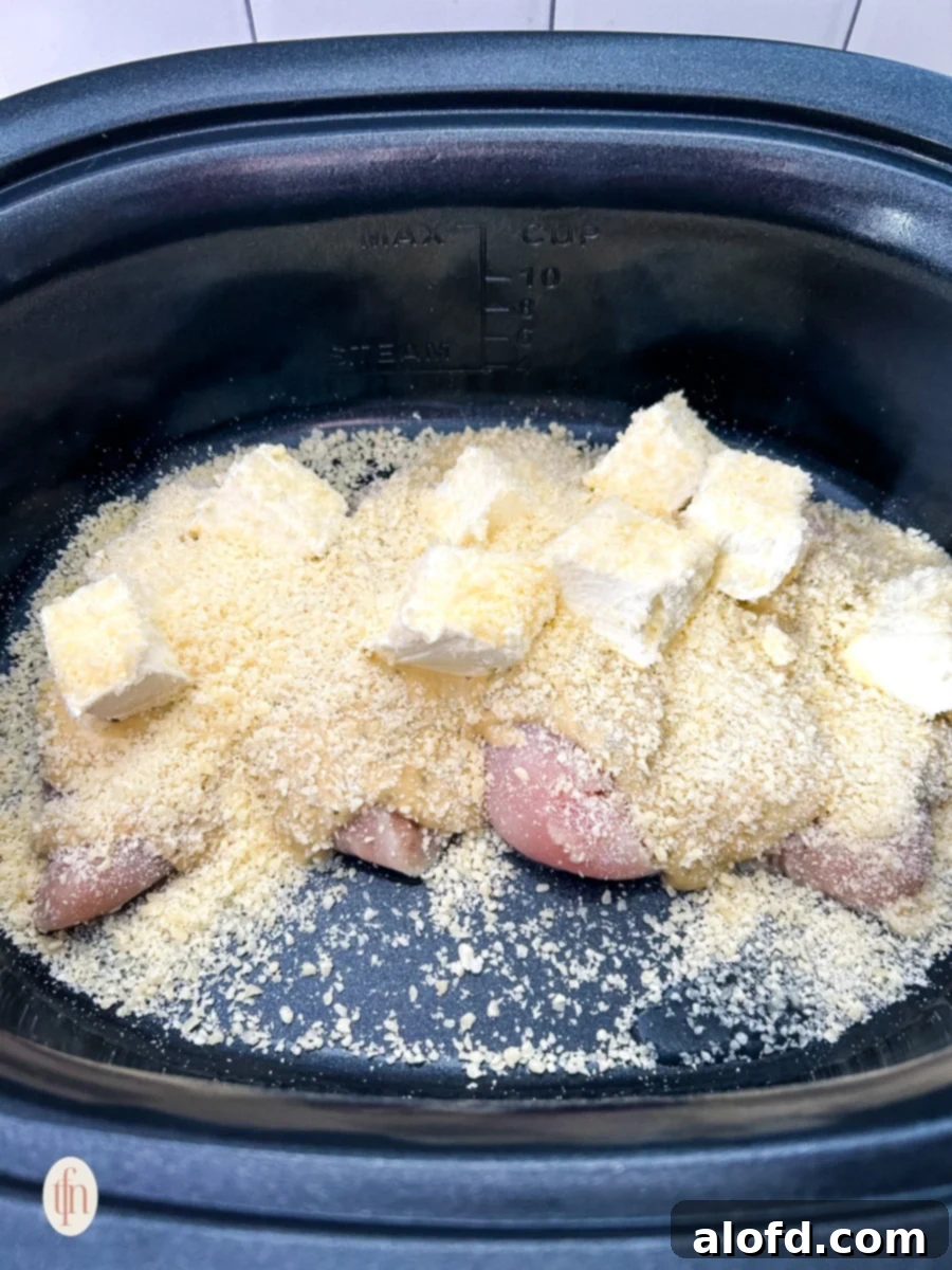 Creamy Garlic Parmesan Chicken Pasta 5 Raw chicken breasts, Parmesan garlic sauce, cream cheese, and grated Parmesan layered in a slow cooker.