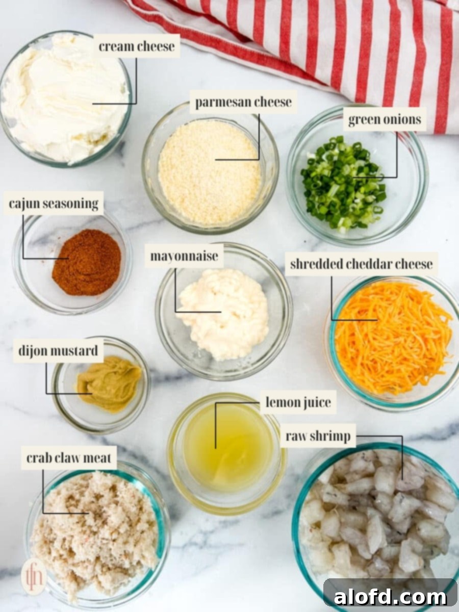 Labeled ingredient image showcasing various components for the crab dip recipe, including cream cheese, mayonnaise, seasonings, shrimp, and crab meat.
