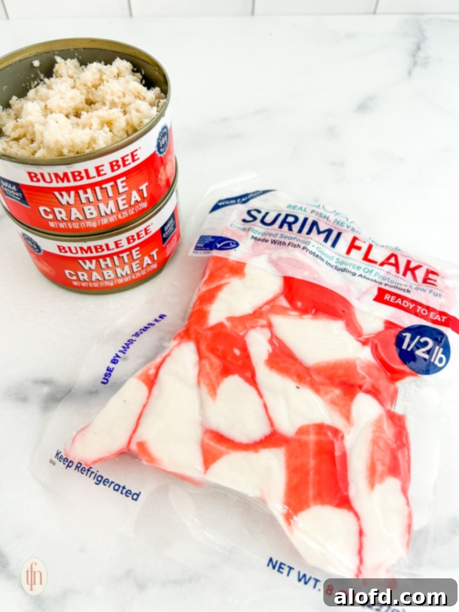 Two cans of white lump crabmeat and a bag of surimi flake, showing the difference between real and imitation crab for Cajun crab dip with shrimp.