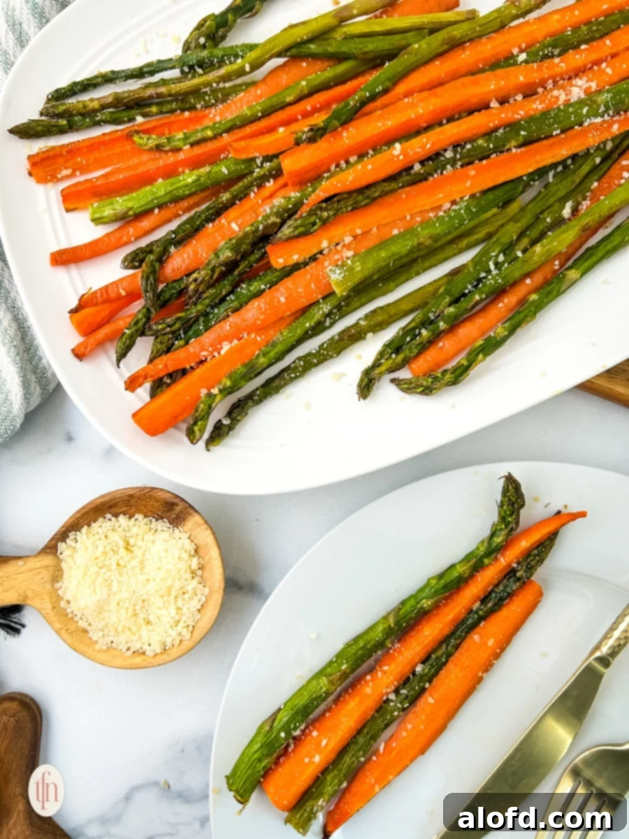 Golden Roasted Carrots and Asparagus 8 A serving plate filled with perfectly roasted carrots and asparagus, accompanied by a wooden spoon, ready to be enjoyed.