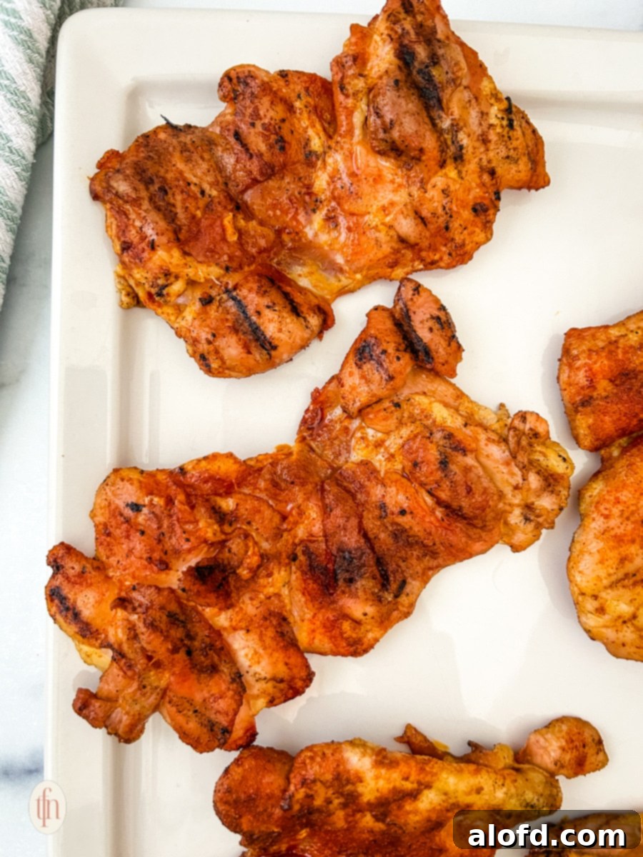 Smoked chicken thighs on a platter.