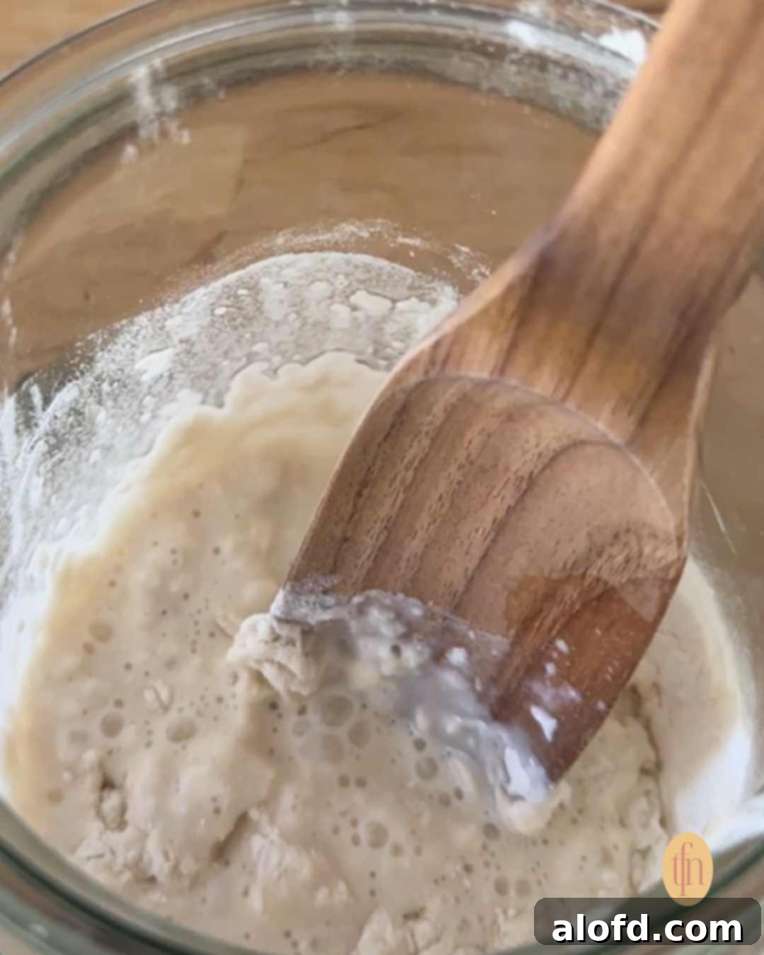 Banish Sourdough Starter Blues 9 Sourdough starter on a Weck jar, with wooden spoon.