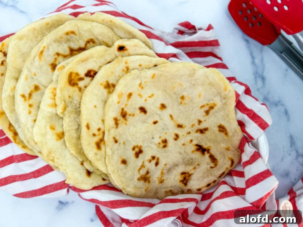 Artisan Sourdough Flatbread 11 Sourdough flatbread on a red kitchen towel, served horizontally.