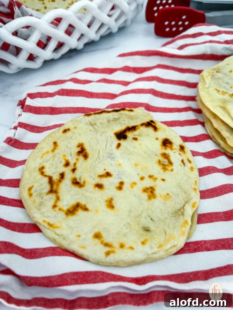 Artisan Sourdough Flatbread 9 Finished sourdough flatbread on a red kitchen towel, glistening with oil.