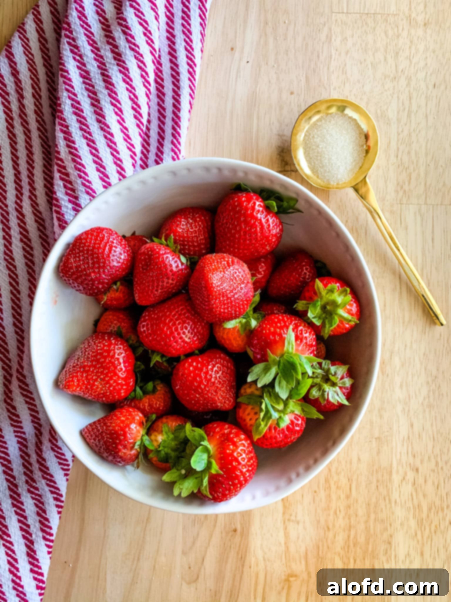 Easy Homemade Bisquick Strawberry Cobbler 3 Fresh strawberries in a bowl, ready for baking.