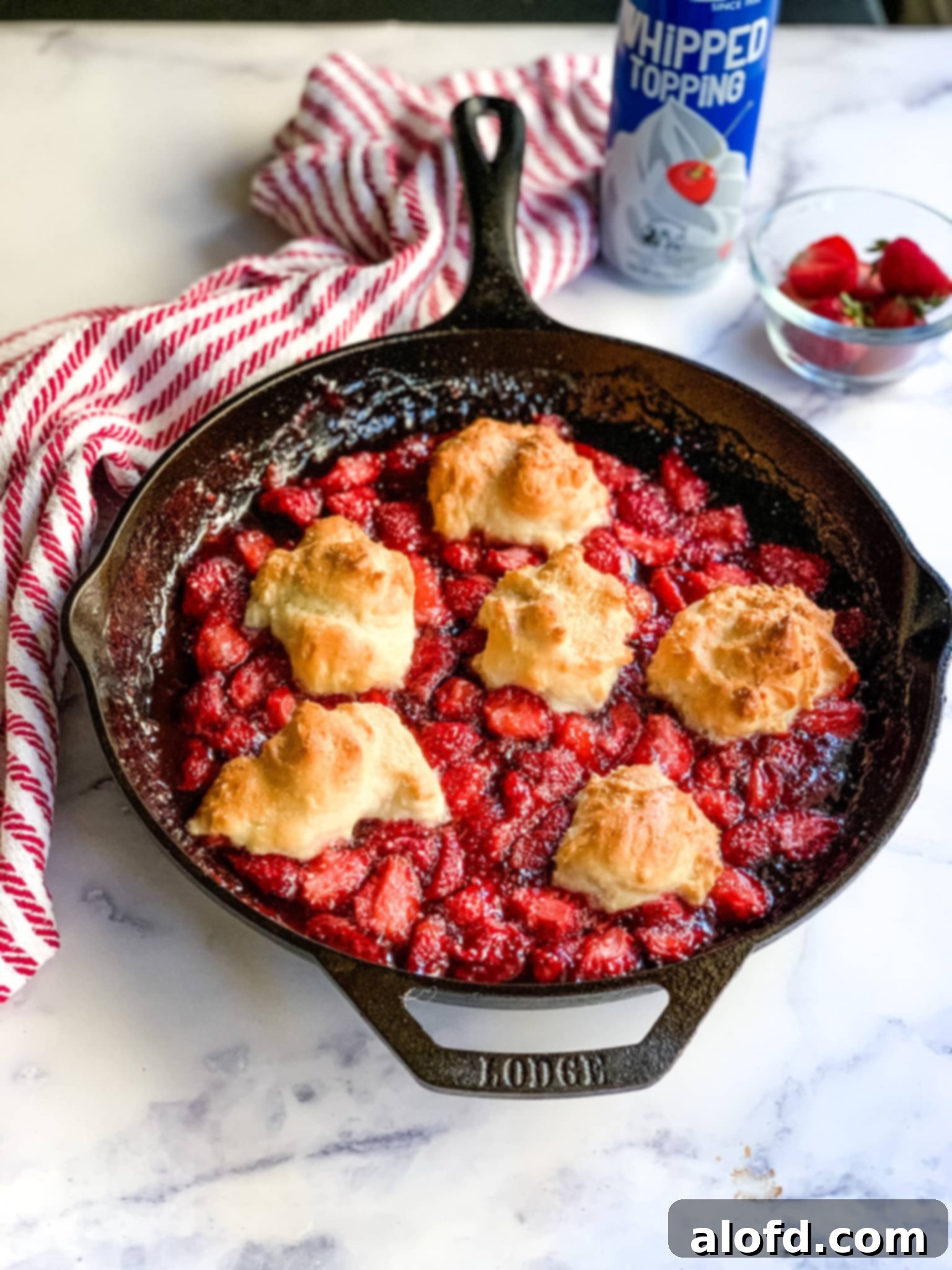 Easy Homemade Bisquick Strawberry Cobbler 8 Strawberry cobbler with golden topping in a cast iron skillet, ready to be served.