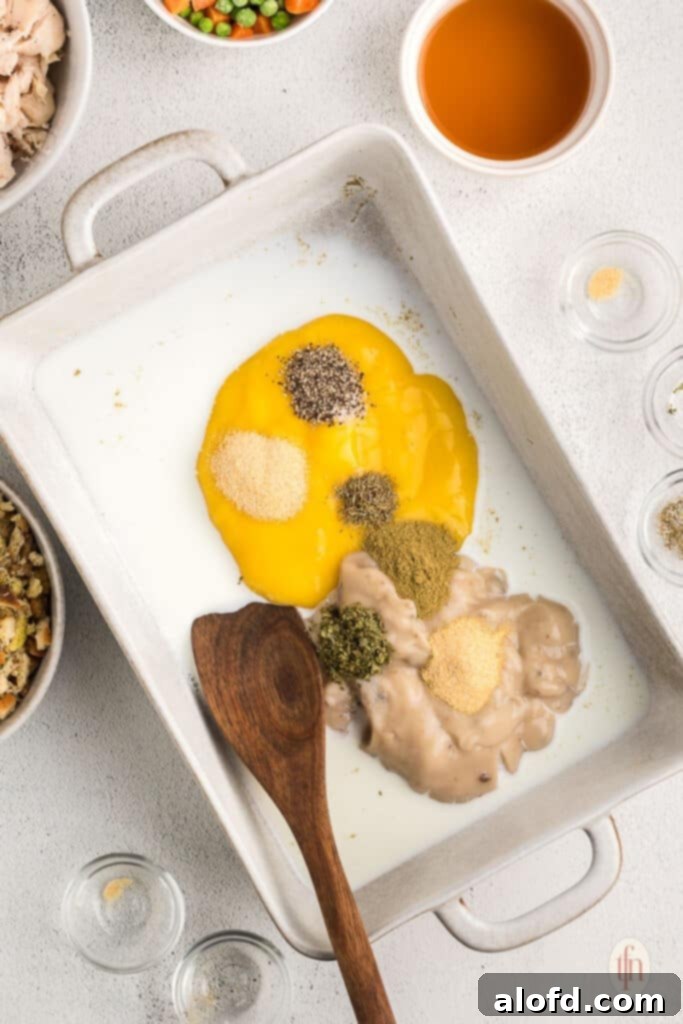 Various ingredients, including canned soups, milk, and seasonings, ready to be mixed for the casserole sauce.