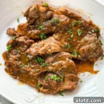 Pork Chops with gravy on a serving platter.