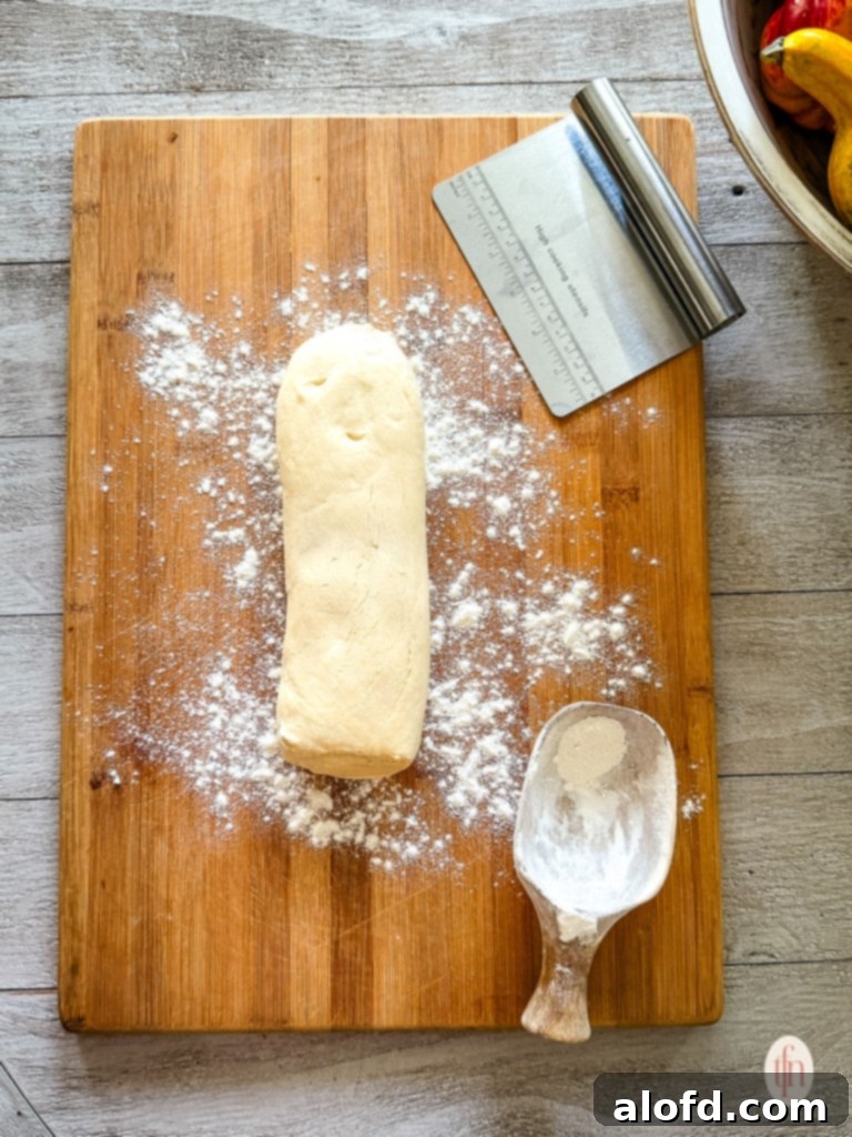 Thawed roll of frozen bread dough ready to cut into pieces.