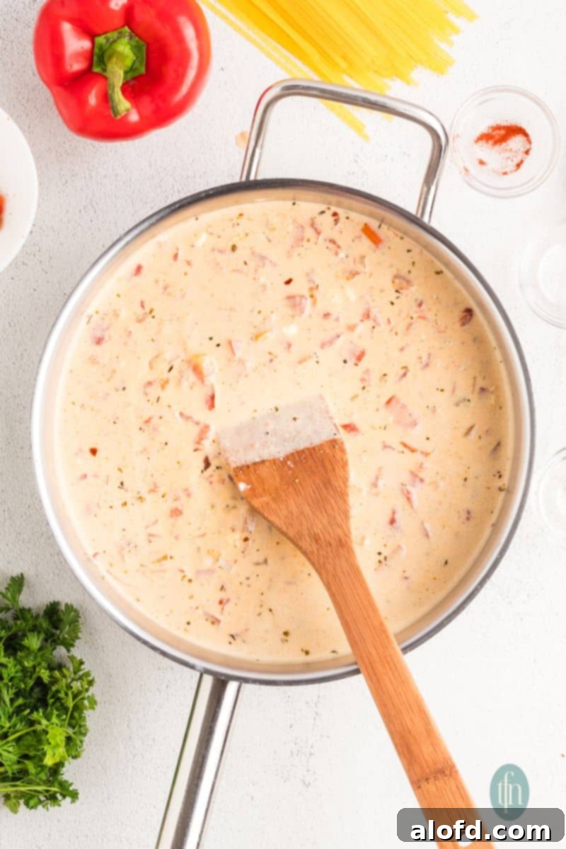 Spicy Rotel Chicken Spaghetti Casserole 12 Smooth, thickened sauce in a pan after cream cheese has fully melted.