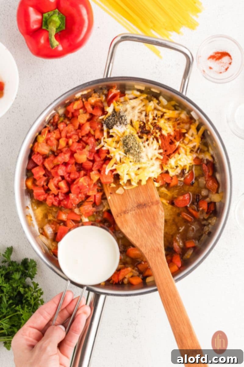 Spicy Rotel Chicken Spaghetti Casserole 8 Rotel, milk, and seasonings being added to sautéed vegetables in a pan.
