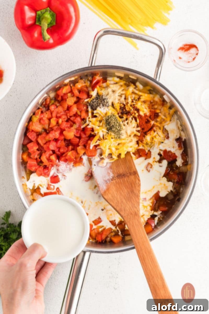 Spicy Rotel Chicken Spaghetti Casserole 9 All sauce ingredients stirred together in a pan, simmering.