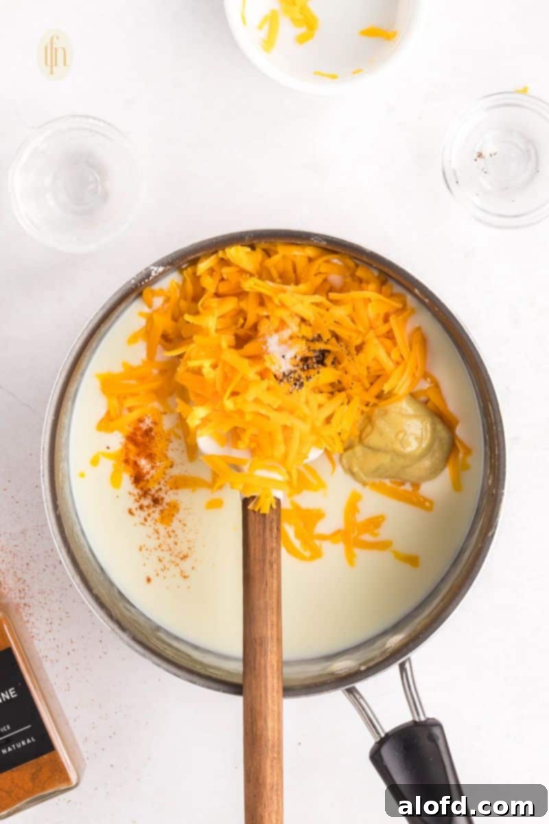 Loaded Pigs in a Blanket Bake 12 Mixed ingredients in a pan with a ladle.