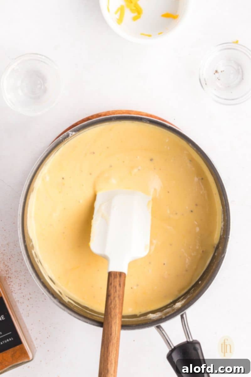 Loaded Pigs in a Blanket Bake 13 Sauce in a pan with ladle.