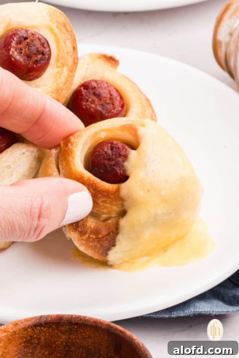 Loaded Pigs in a Blanket Bake 4 A plate of pigs in a blanket with sauce.