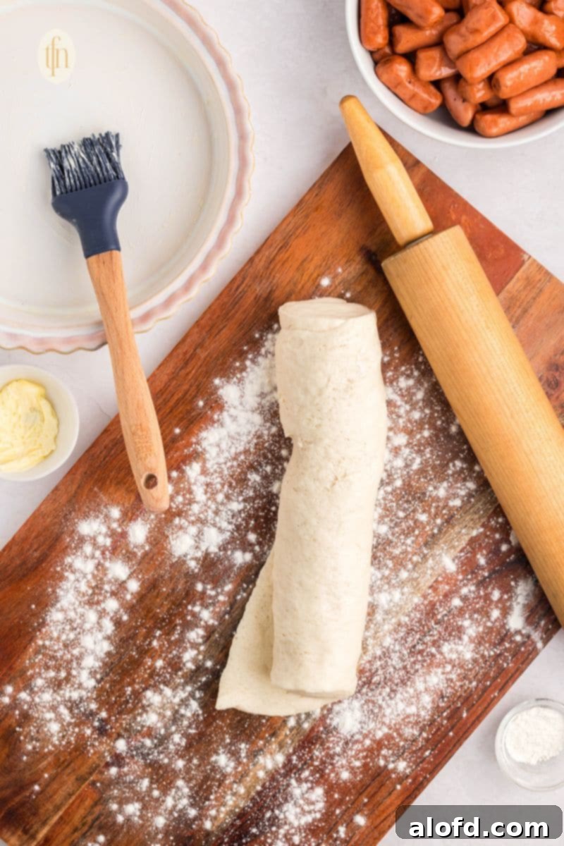 Loaded Pigs in a Blanket Bake 8 Floured dough on a wooden board with rolling pin.